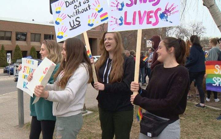 Chazley Kesler (right) was one of more than 100 people who rallied in Lethbridge on Tuesday to support gay-straight alliances.