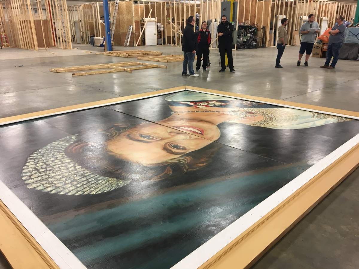 Portrait of Queen Elizabeth the Second being housed in a warehouse