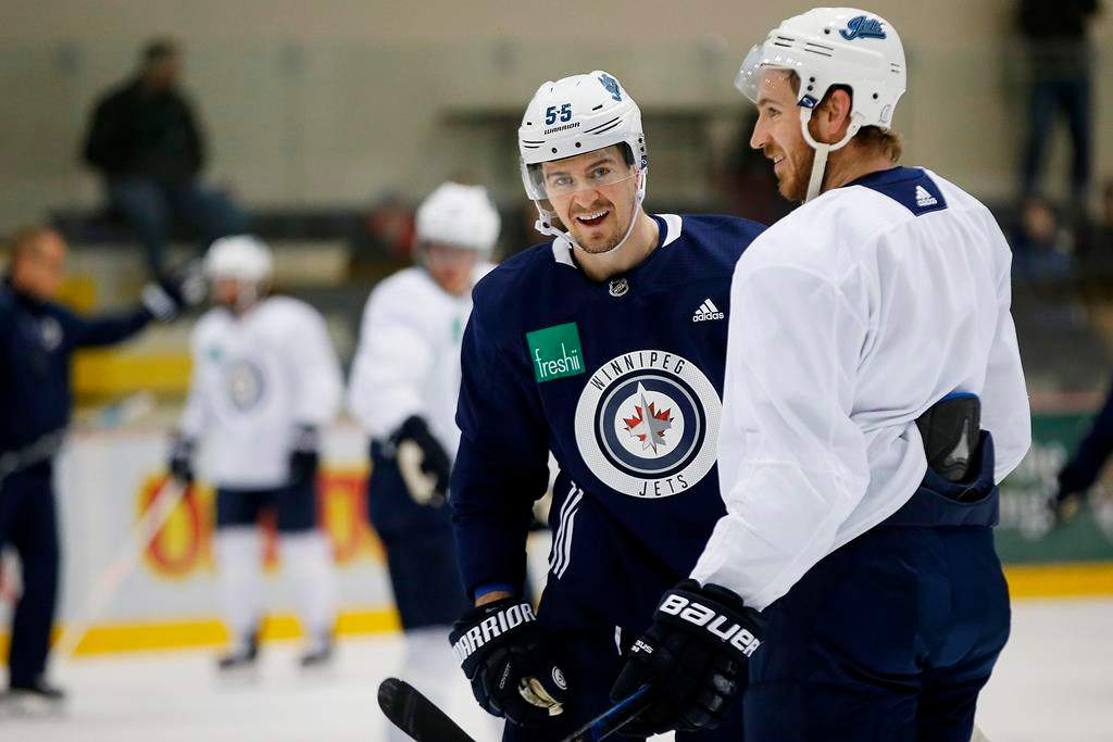 Winnipeg Jets' Mark Scheifele (55) and Kevin Hayes (12) joke around during practice prior to their first round of NHL playoff action against the St. Louis Blues in Winnipeg, Monday, April 8, 2019. THE CANADIAN PRESS/John Woods.