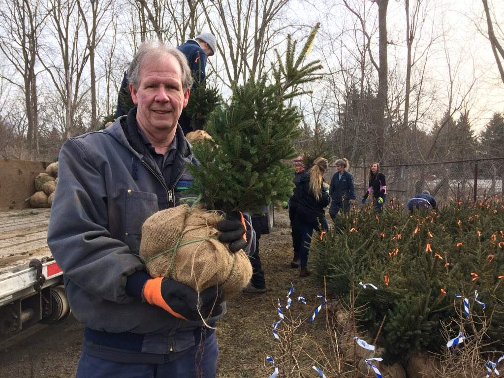 Upper Thames River Conservation Authority Forester, John Enright, holds one of the trees that'll be planted as part of a spring blitz. \.
