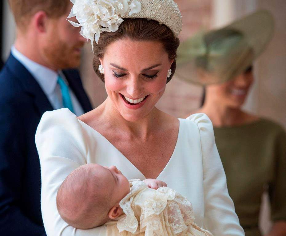 FILE - In this Monday, July 9, 2018 file photo, Kate, Duchess of Cambridge carries Prince Louis as they arrive for his christening service at the Chapel Royal, St James's Palace, London. The youngest child of Prince William and his wife Kate is about to celebrate his first birthday. Prince Louis will mark the milestone Tuesday, April 23, 2019.