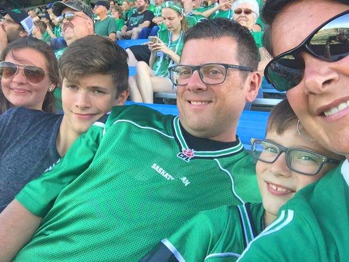 Kylan (second from the left) and the rest of the MacKenzie family at a Saskatchewan Roughriders game.