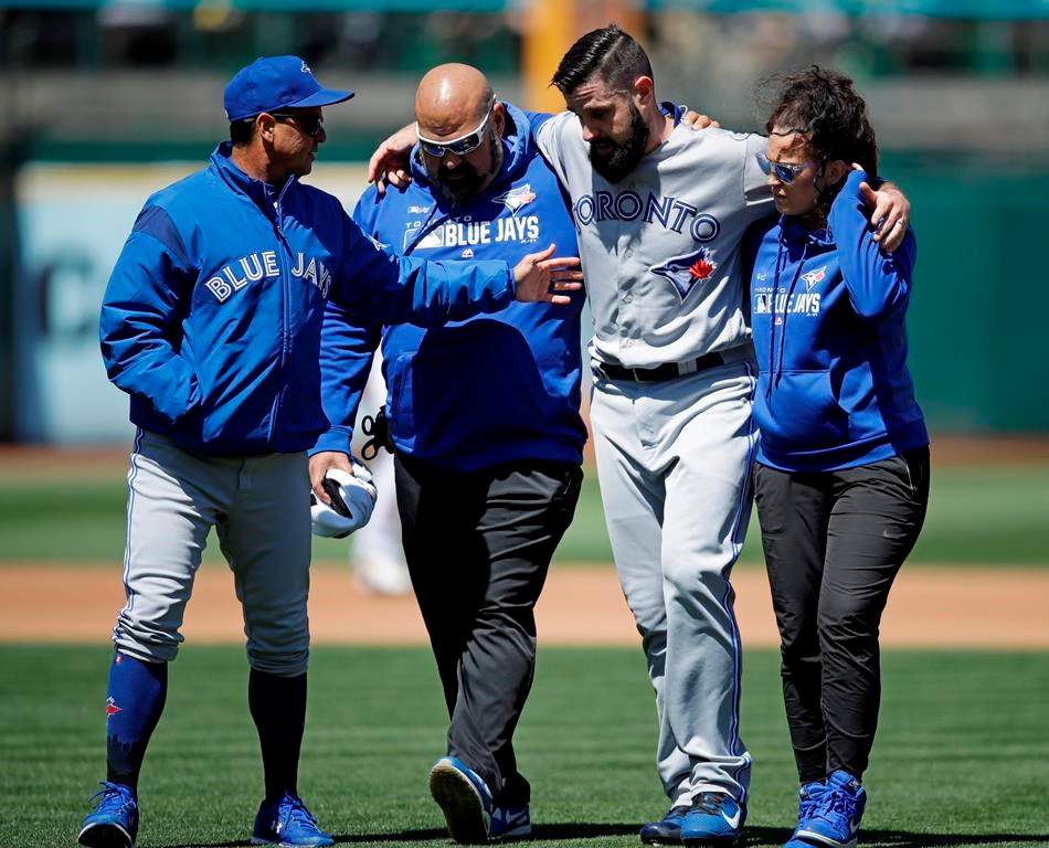 An ACL tear in the left knee forced an early end for the season of Toronto Blue Jays pitcher Matt Shoemaker, second from right, in April 2019.