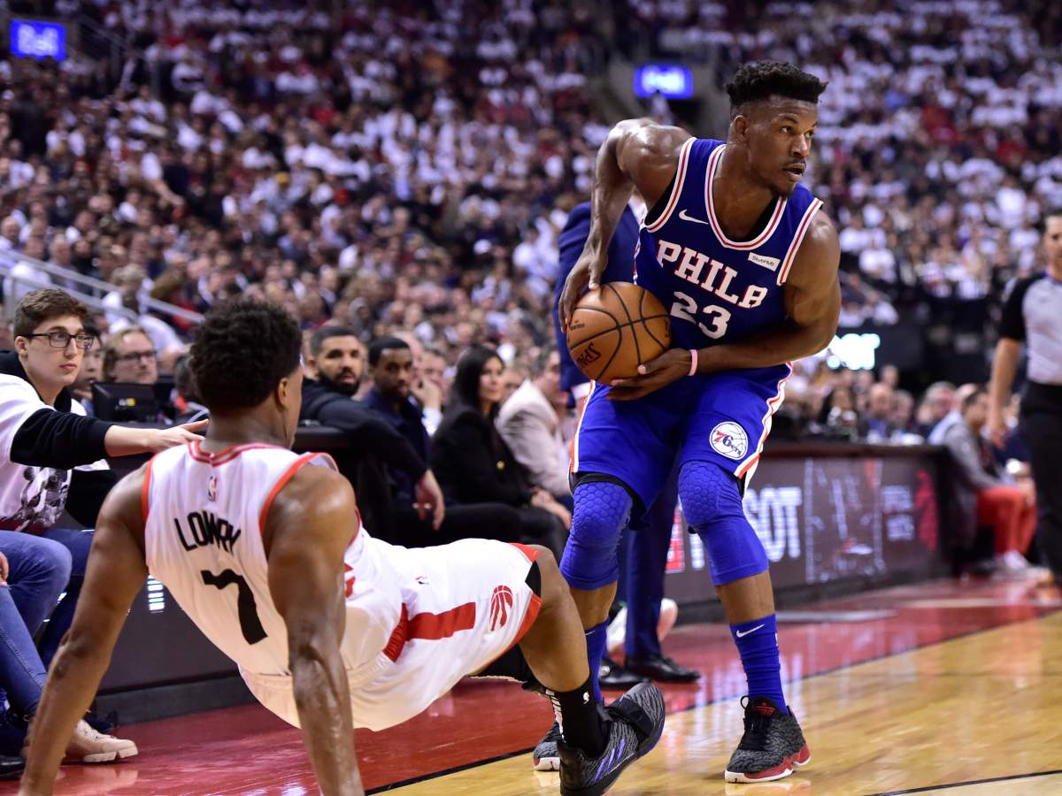 Philadelphia 76ers guard Jimmy Butler (23) looks to pass as Toronto Raptors guard Kyle Lowry (7) falls while defending during first half, second round NBA basketball playoff action in Toronto, on Monday, April 29, 2019.