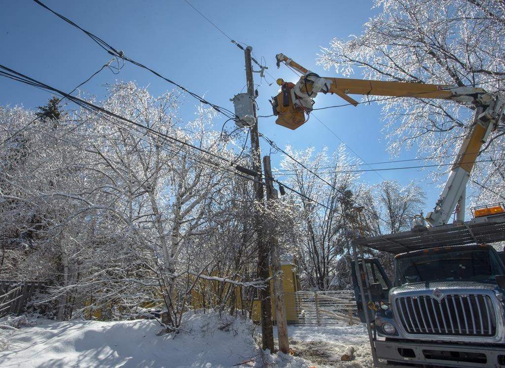Hydro Quebec workers repair power lines in Laval, Que., Wednesday, April 10, 2019 after an ice storm hit the area.