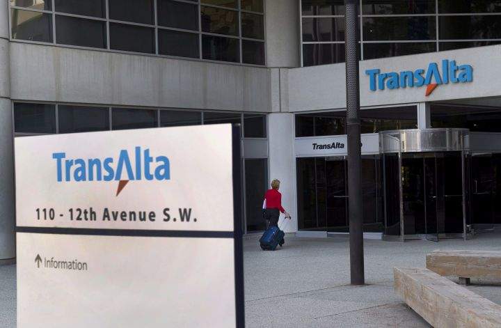 A woman walks towards the entrance of the TransAlta headquarters building in Calgary on April 29, 2014. 