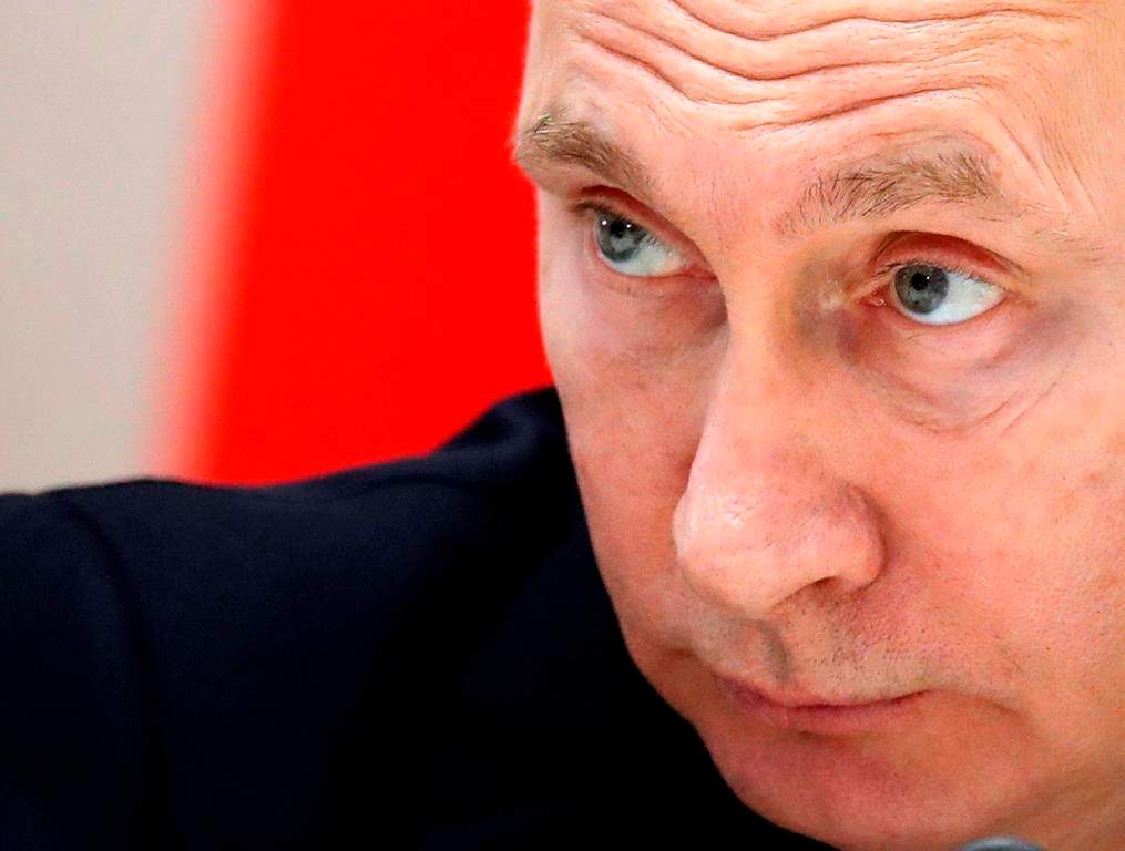 FILE - In this Feb. 14, 2019, file photo, Russian President Vladimir Putin listens during a meeting in the Bocharov Ruchei residence in the Black Sea resort of Sochi, Russia.