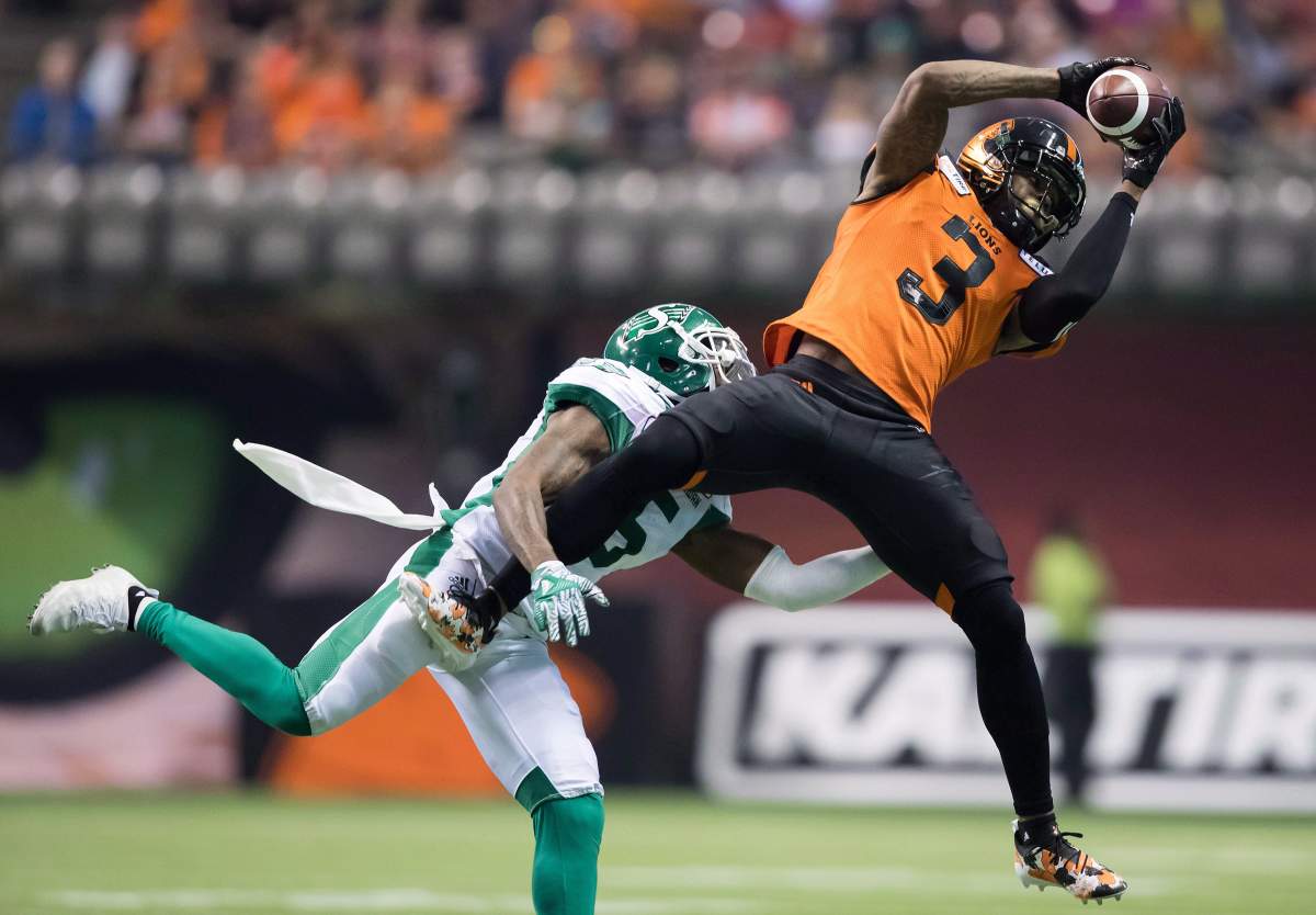 B.C. Lions’ Ricky Collins Jr. (3) makes a reception as Saskatchewan Roughriders’ Crezdon Butler defends during the first half of a CFL football game in Vancouver, on Saturday August 25, 2018.