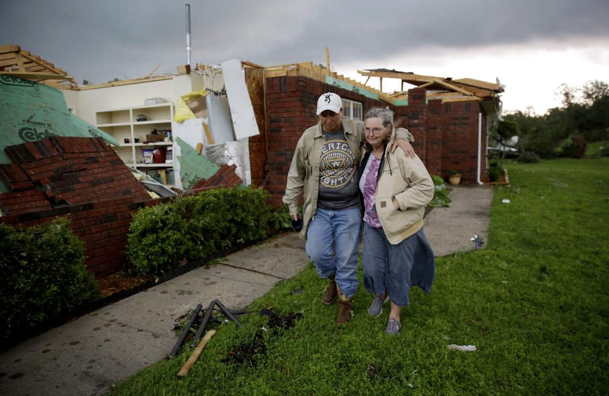 Karen Spencer is helped to her storm cellar by her daughter Tammi Foster in Peggs, Okla. Tuesday, May 21, 2019. Spencer’s home was hit by an apparent tornado on Monday night. She and her husband Ed didn’t have time to make it to the cellar on Monday and rode the storm out in their home.