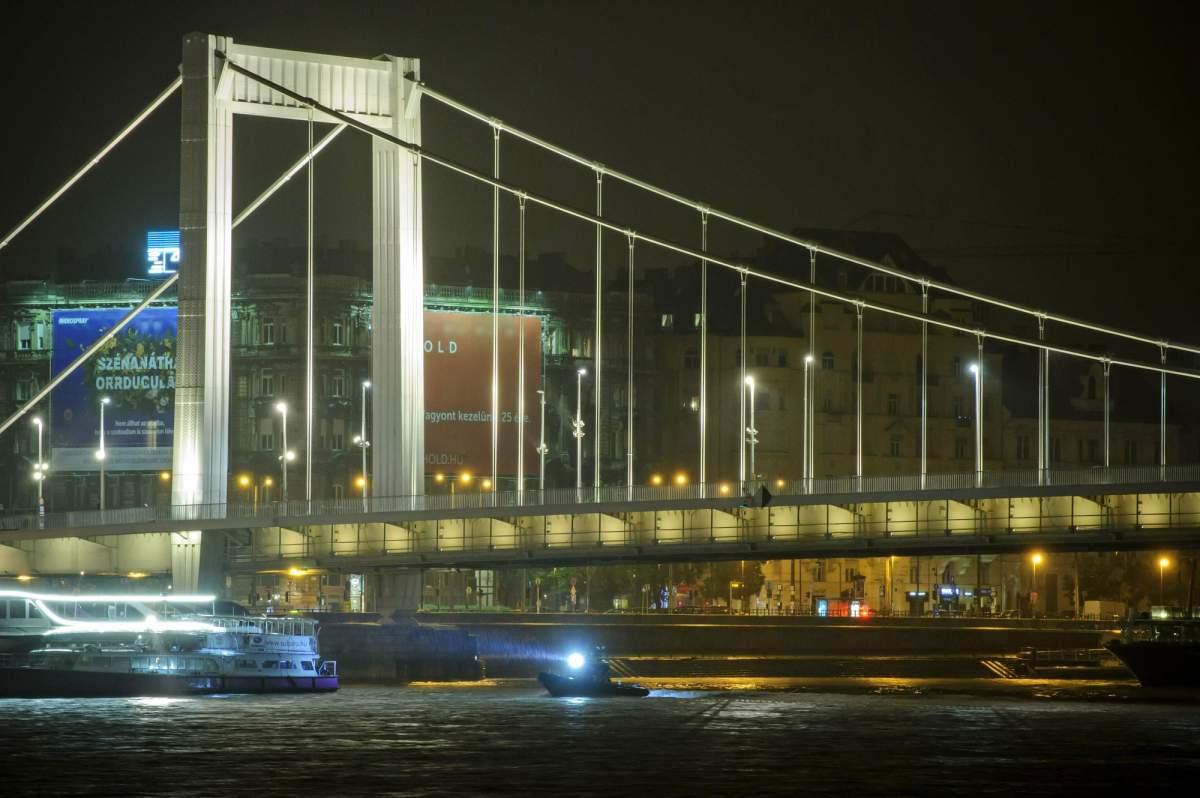 A rescue boat searches for victims late Wednesday, May 29, 2019, after a tourist boat crashed with a river cruise boat, in River Danube in Budapest.