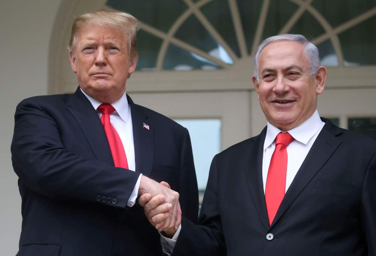 U.S. President Donald Trump shakes hands with Israel's Prime Minister Benjamin Netanyahu as they pose on the West Wing colonnade in the Rose Garden at the White House in Washington, U.S., March 25, 2019. 