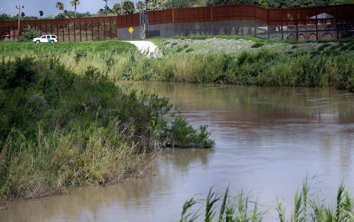  In this June 26, 2018, file photo, a U.S. Border Patrol vehicle sits above the Rio Grande River at the U.S. - Mexico border in Brownsville, Texas.