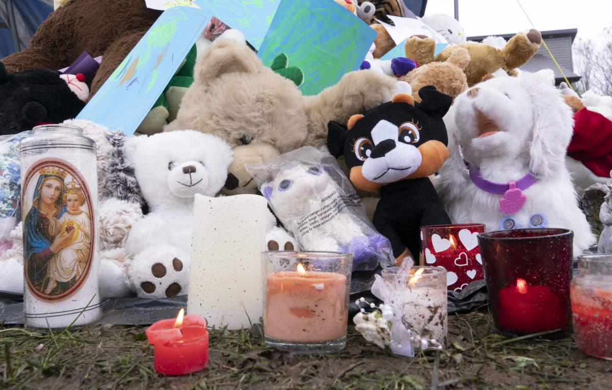 Stuffed animals are seen in front of the house where lived a 7-year-old girl who was found in critical condition in her home on Monday, April 29, in Granby, Que.