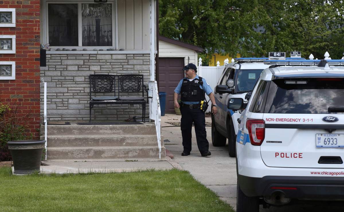 Chicago police watch over a home in Chicago, Wednesday, May 15, 2019, where Marlen Ochoa-Lopez was found strangled and her baby cut from her womb.