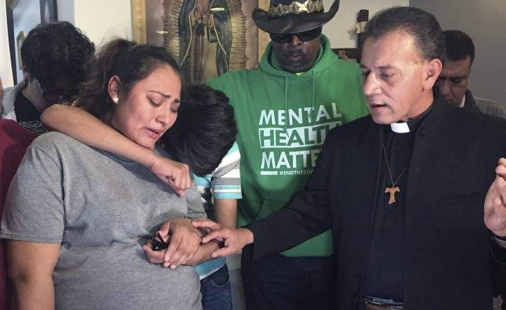 In this Tuesday, May 21, 2019 photo provided by WBEZ Radio is Adilene Marquina, left, as she sobs after announcing she will be seeking sanctuary inside Faith, Life and Hope Mission church on Chicago's Southwest Side. 