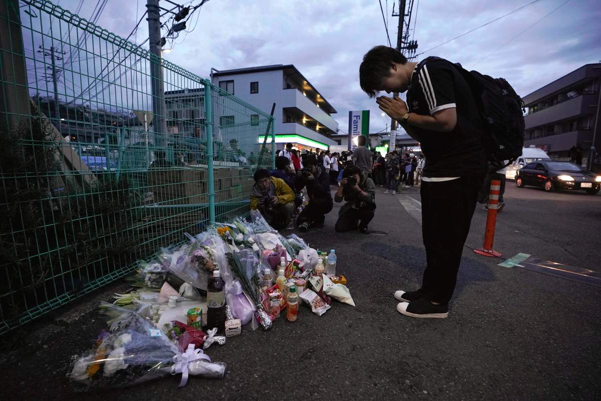 A man pays respects at a makeshift memorial for the victims of a knife attack Tuesday, May 28, 2019, in Kawasaki, just outside Tokyo.