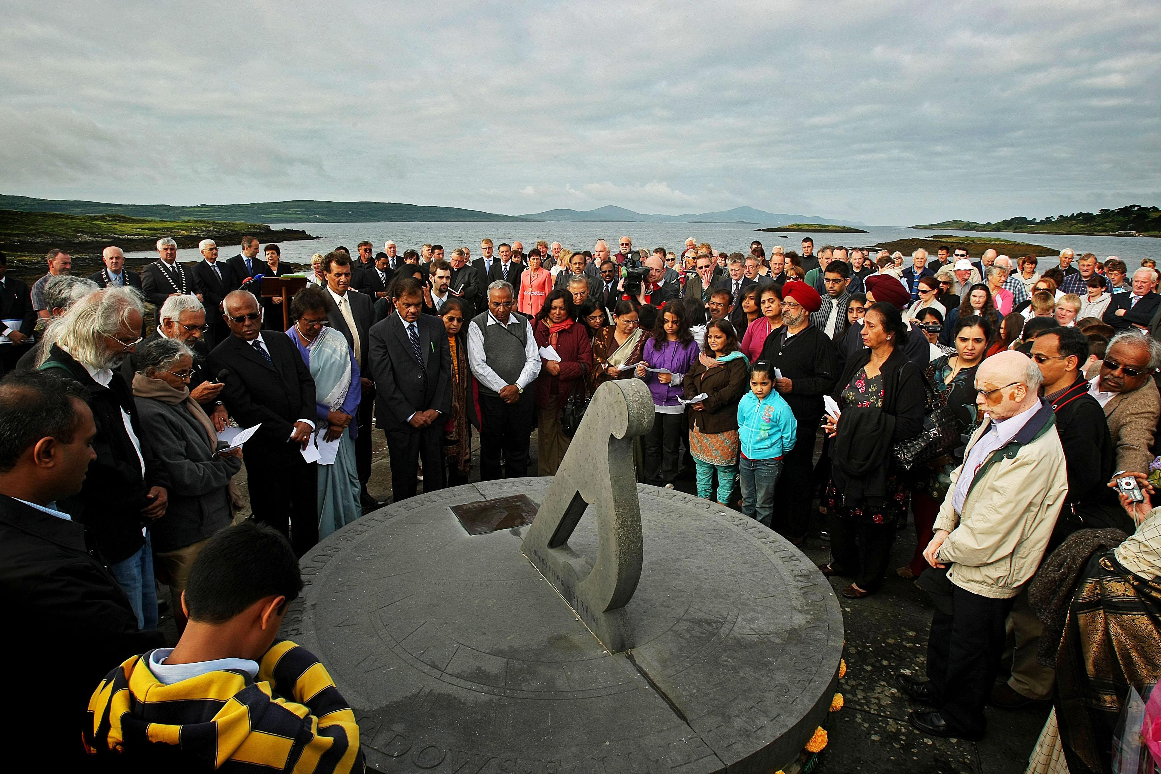 Relatives of Air India bombing victims gather around the sundial marking 8:13 a.m., the time of the crash, at the memorial in Ahakista on the Sheep’s Head peninsula, West Cork, Ireland.