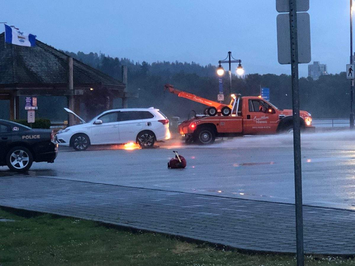 Pictures show the car rescued from the water catching on fire after getting salvaged.