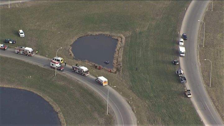 Emergency crews respond to  a car in a pond in the area of Deerfoot Trail and Stoney Trail S.E. on Tuesday, May 7, 2019. 
