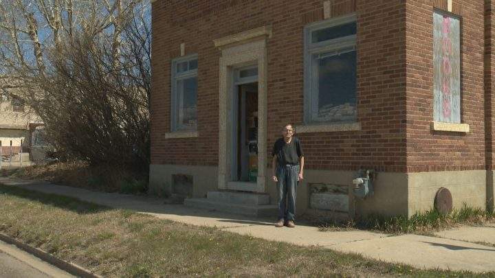 Ralph Crawford stands in front of his bookstore in Perdue, Sask.