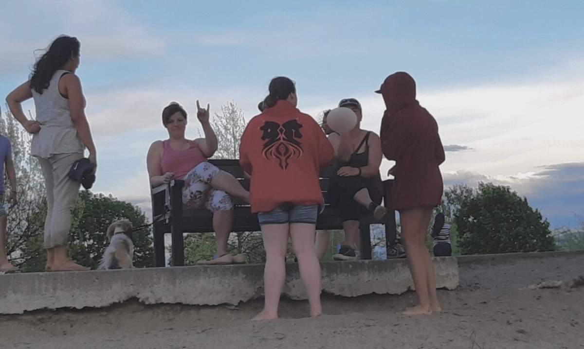 A group of people as photographed by Clementine Smithereens after they were confronted for being topless on a Kelowna beach.