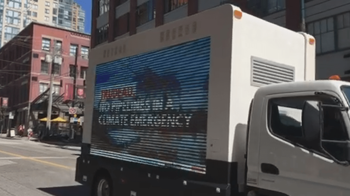 A jumbotron truck with an anti-pipeline message passes in front of a protest at the Opus Hotel on Wednesday, May 22, 2019.