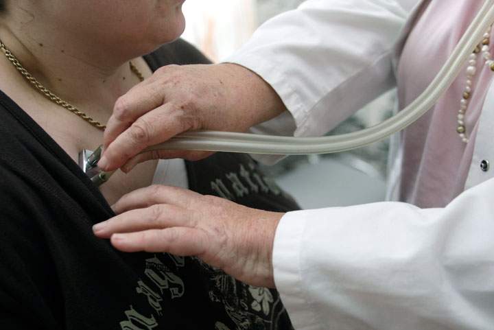 A doctor examines a patient.