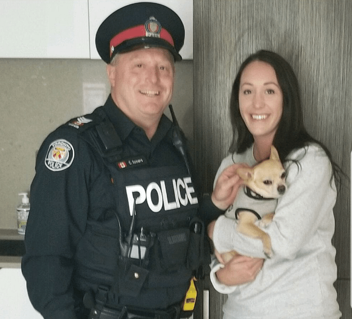 Malachi, a chihuahua, pictured with a Good Samaritan (right) and Toronto Police Det. Sgt. Somers (left), after the dog went missing over the Victoria Day long weekend.