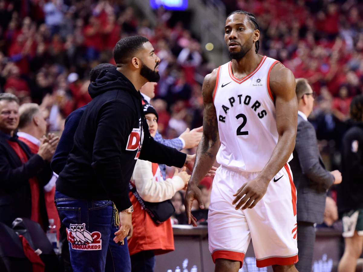 Drake congratulates Toronto Raptors forward Kawhi Leonard (2) as he leaves the court with three minutes left in the in second-half action in Game 4 of the NBA Eastern Conference Final against the Milwaukee Bucks in Toronto on Tuesday, May 21, 2019. The Raptors defeat the Bucks 120-102. THE CANADIAN PRESS/Frank Gunn