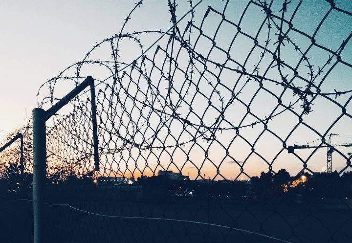 A barbed wire fence is shown in a file photo. Authorities say 29 people were killed in a confrontation at a police station jail in central Venezuela.