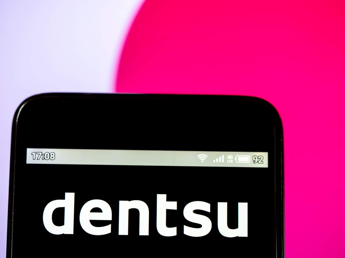 A Dentsu Inc. logo seen displayed on a smartphone.