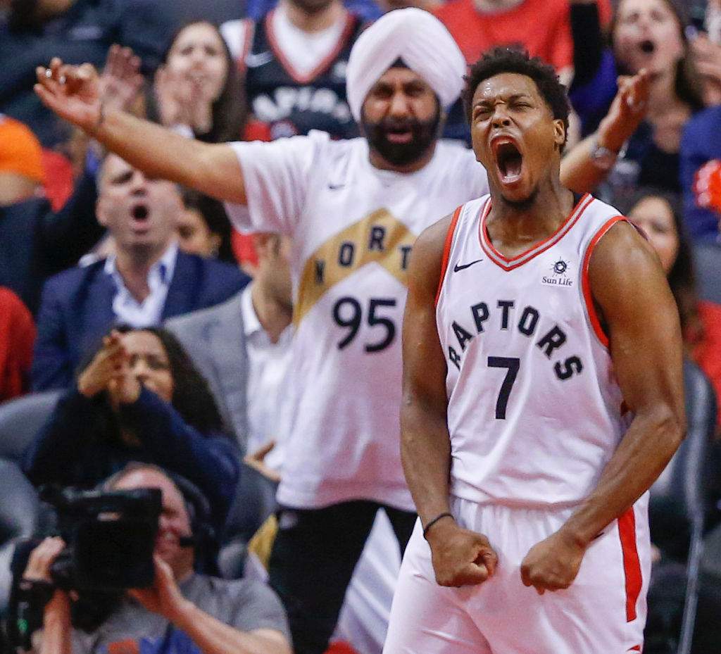 Toronto Raptors guard Kyle Lowry (7) lets out a scream after making a difficult drive as superfan Nav Bhatia yells in support. Toronto Raptors vs. Orlando Magic in 2nd half action of Round 1, Game 5 of NBA playoff play at Scotiabank Arena.
