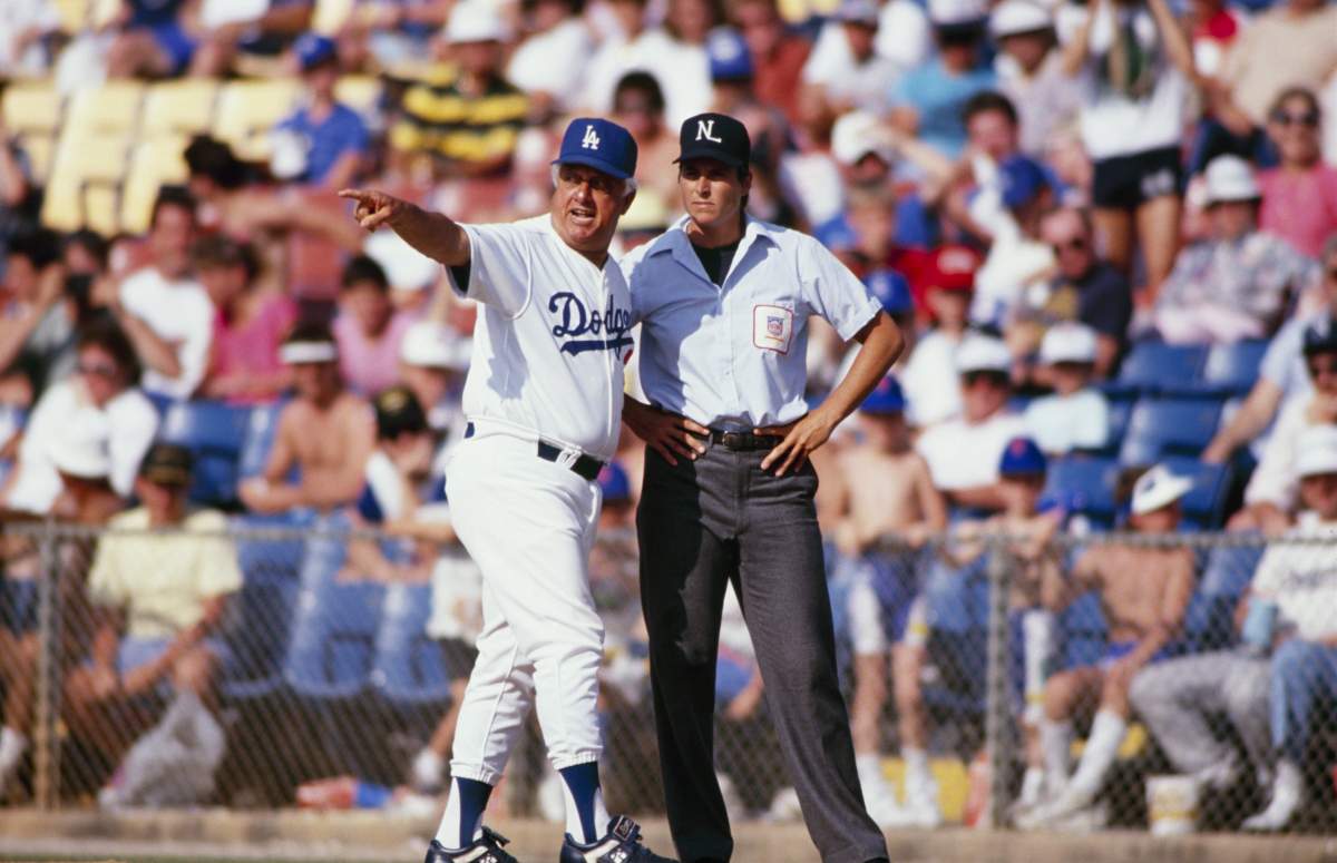 Manager Tommy Lasorda of the Los Angeles Dodgers speaks with umpire Pam Postema during a Spring Training game in March 1989 in Vero Beach, Florida.