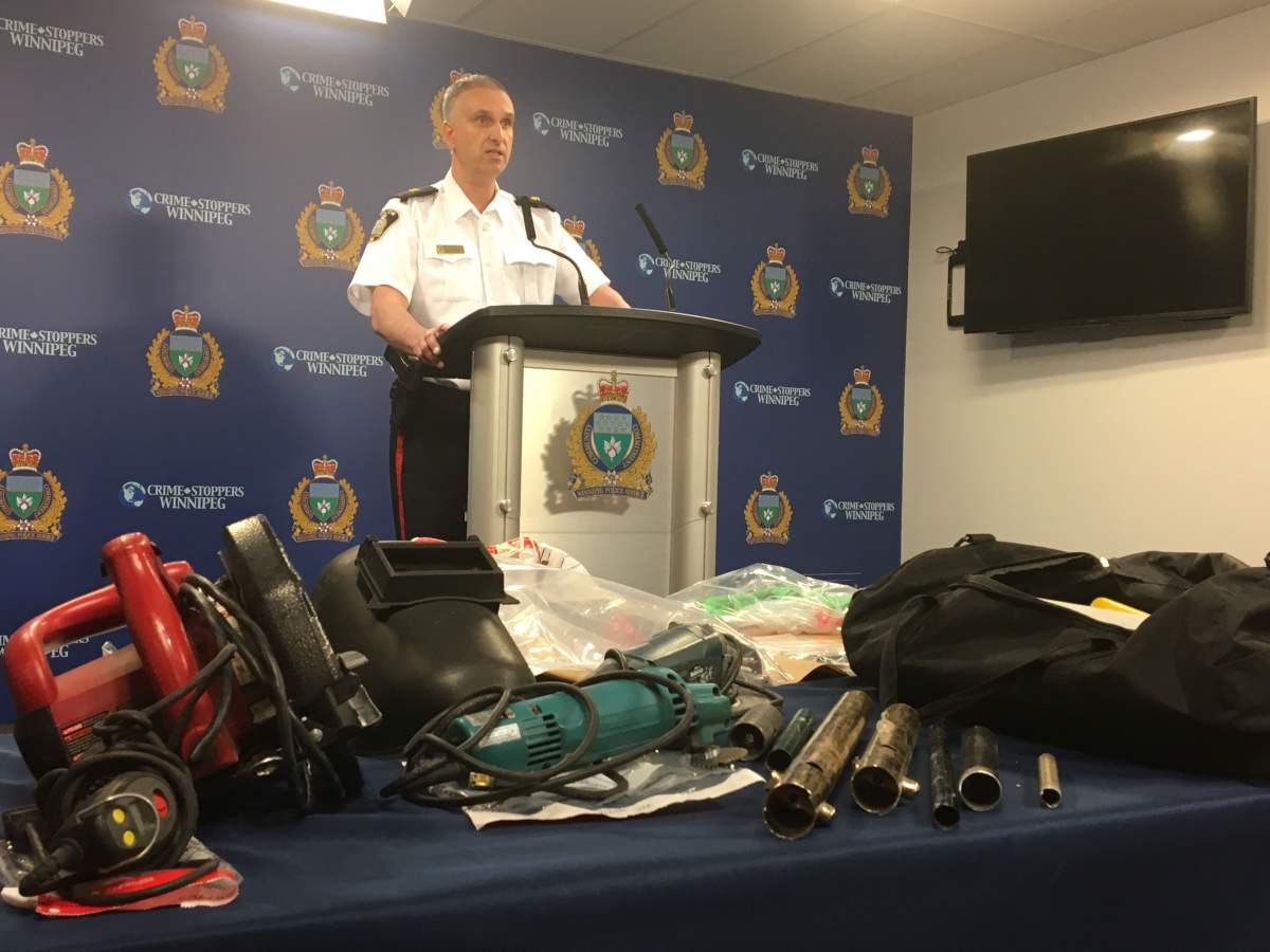 Insp. Max Waddell with a table full of zip guns taken off of Winnipeg streets.