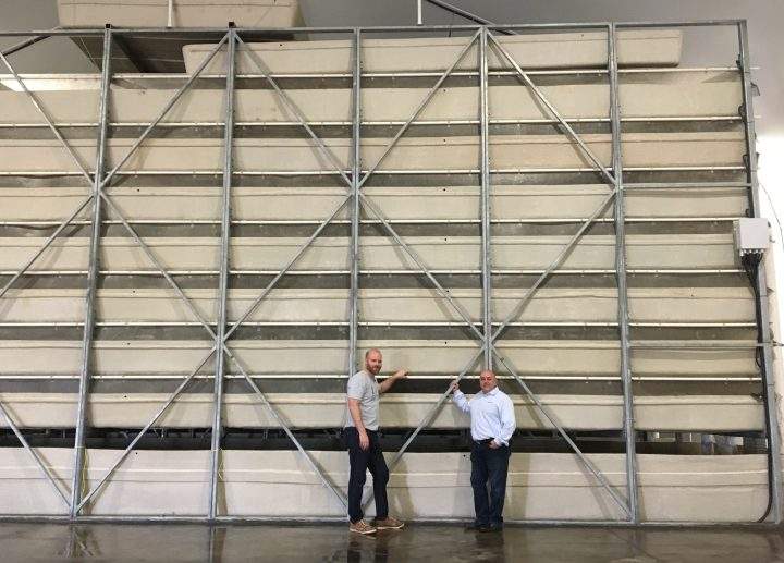 Keith Driver and Tom Grande stand in front of the tanks at the shrimp farm near Strathmore, Alta., on May 1, 2019.