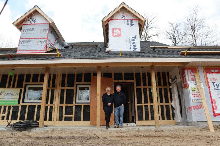 Koko and Robert Saar stand in front of their Wasaga Beach passive house, which is expected to complete construction in the summer.