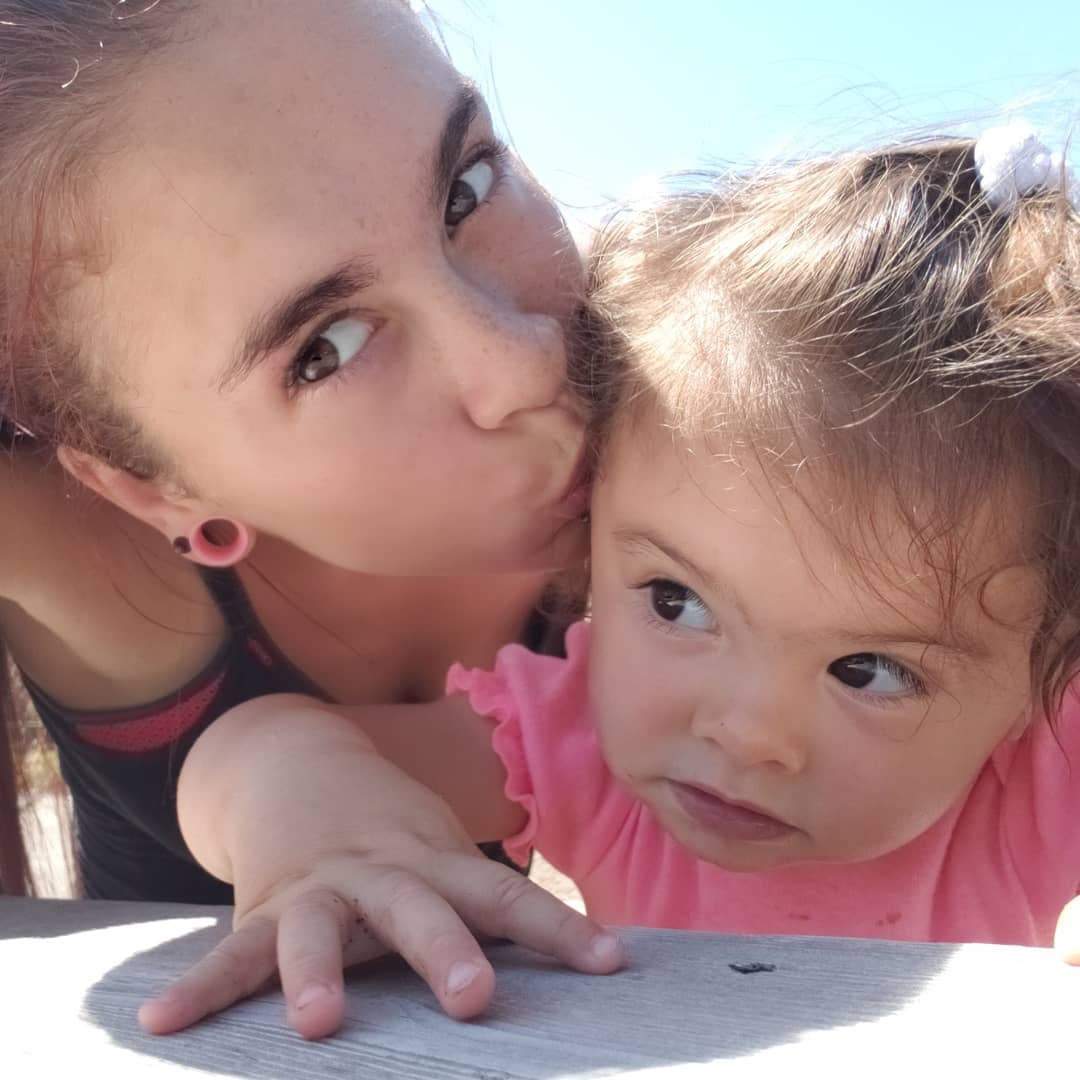 Tia Hildebrand kisses her daughter, Kairi.