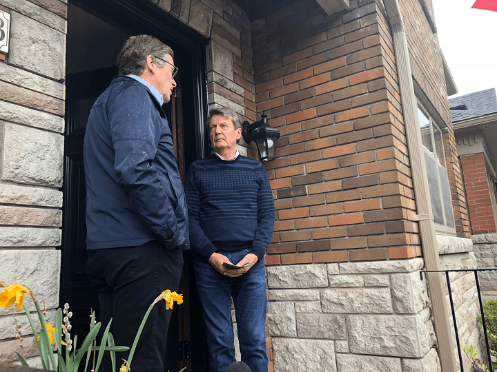 Mayor Tory speaking to a resident about provincial budget cuts on Saturday.