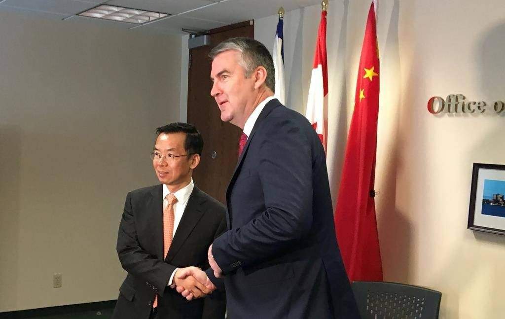China's ambassador to Canada Lu Shaye shakes hands with Nova Scotia Premier Stephen McNeil in Halifax on Wednesday, May 29, 2019.