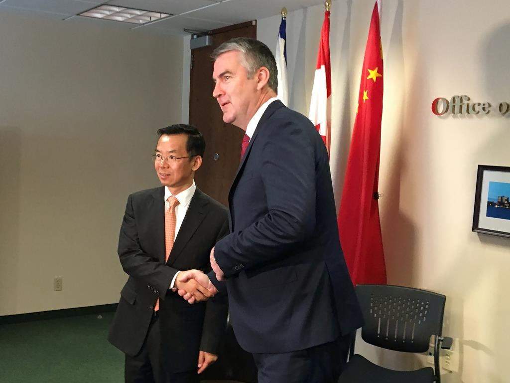 China's ambassador to Canada Lu Shaye shakes hands with Nova Scotia Premier Stephen McNeil in Halifax on Wednesday, May 29, 2019.