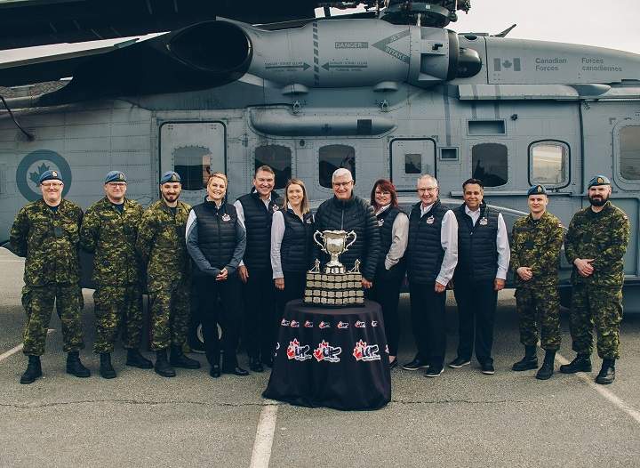 Surrounded by members of the military, members of the 2020 host committee from Kelowna stand behind the Memorial Cup. From left: Renta Mills, Tom Dyas, Jillian Wegner, Bruce Hamilton, Anne-Marie Hamilton, Gavin Hamilton and Thom Killingsworth. 