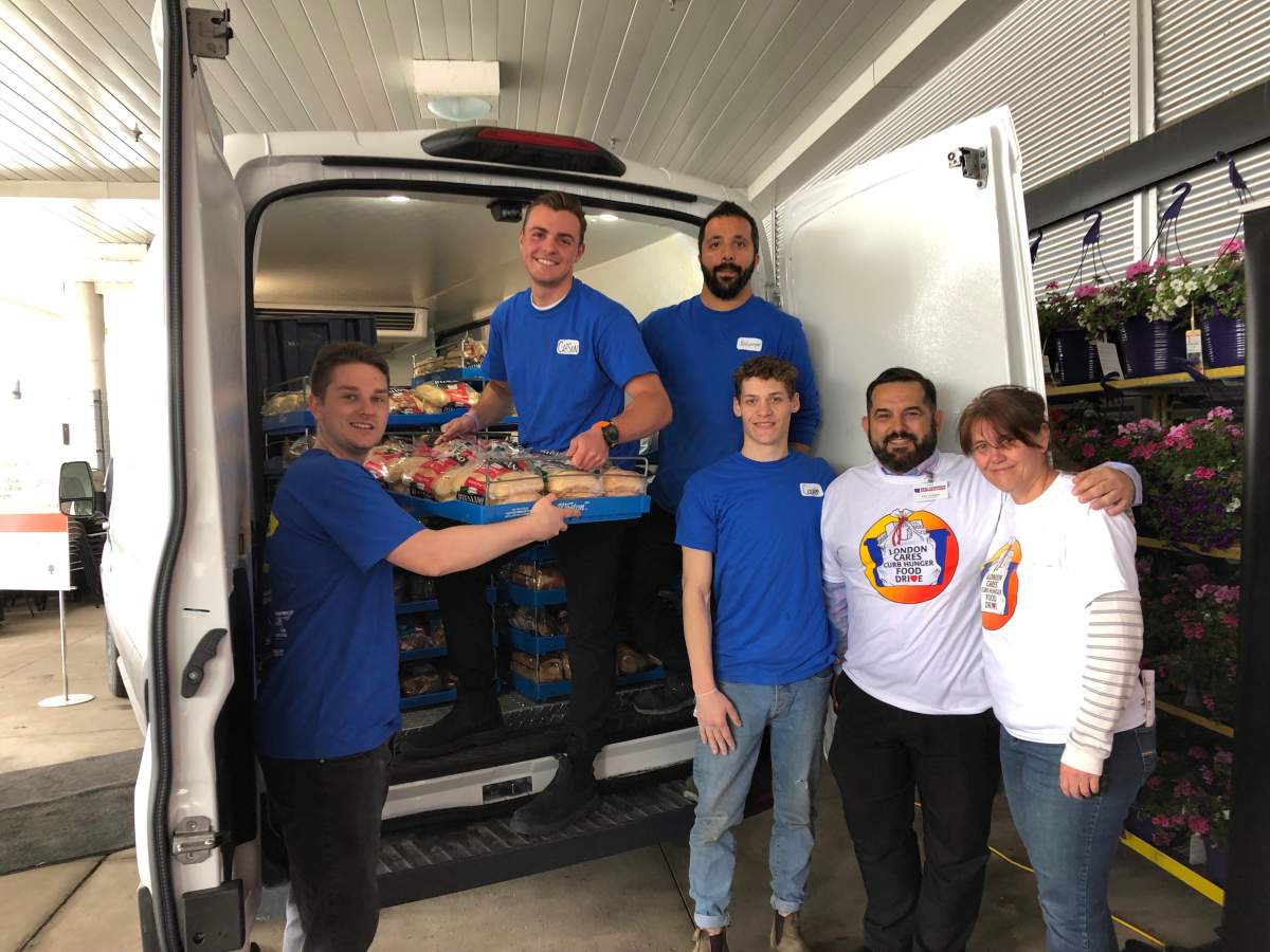 London Food Bank co-executive director Jane Roy, right, poses with volunteers from the Real Canadian Superstore on Oxford Street west.