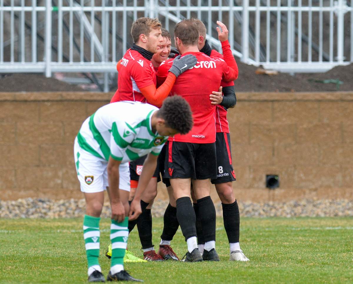 Members of Cavalry FC come together in an April 26, 2019, preseason game against Foothills FC.