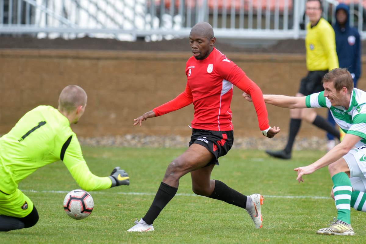 Cavalry FC forward Jordan Brown evades Foothills FC defenders in a April 26, 2019, preseason game.