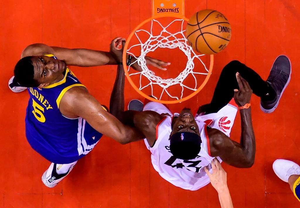 Toronto Raptors forward Pascal Siakam (43) eyes the ball against Golden State Warriors centre Kevon Looney (5) during second half NBA championship basketball finals action in Toronto on Thursday, May 30, 2019. THE CANADIAN PRESS/Nathan Denette.