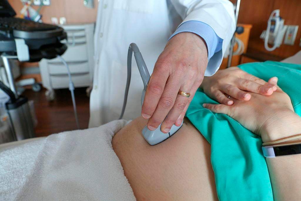 A doctor at a hospital in Chicago performs an ultrasound scan on a pregnant woman in this photo from May 2019.