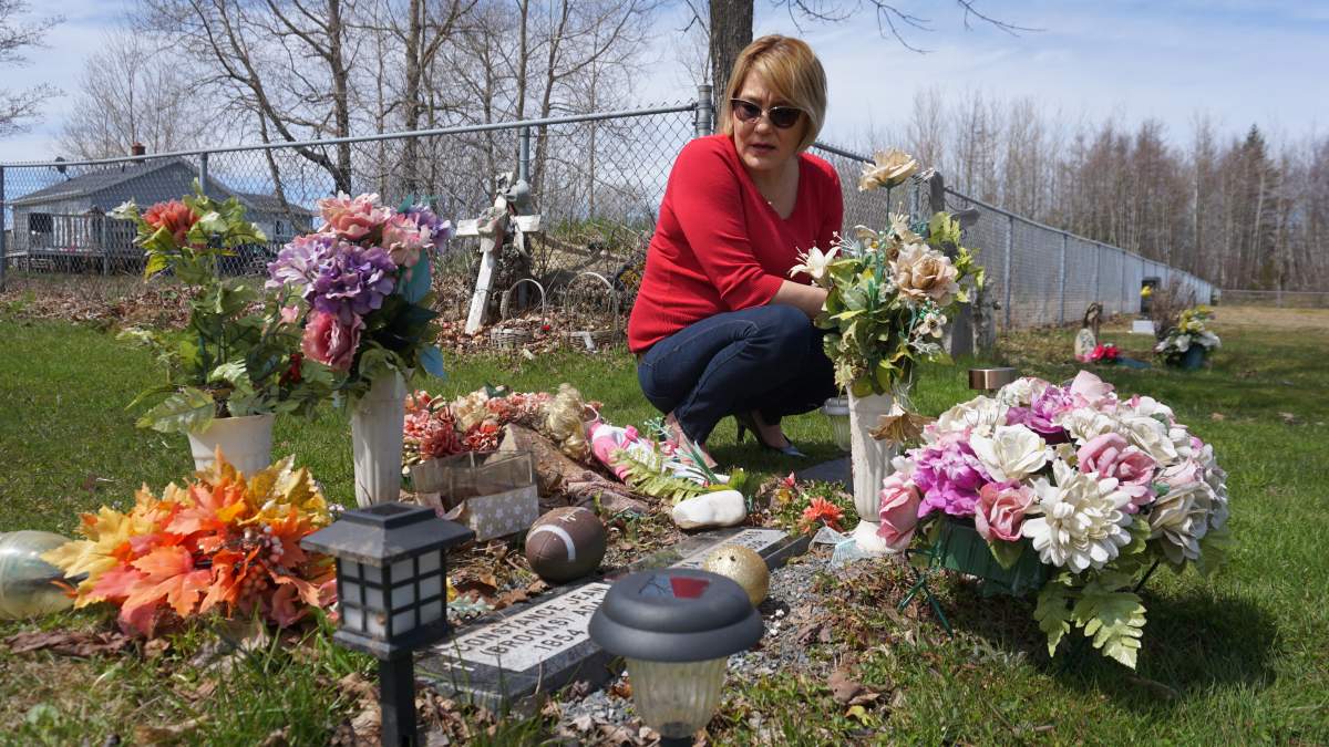 Vanessa Brooks looks over her sister Tanya’s grave behind their house in Millbrook First Nation, N.S. on Mon. May 6, 2019.