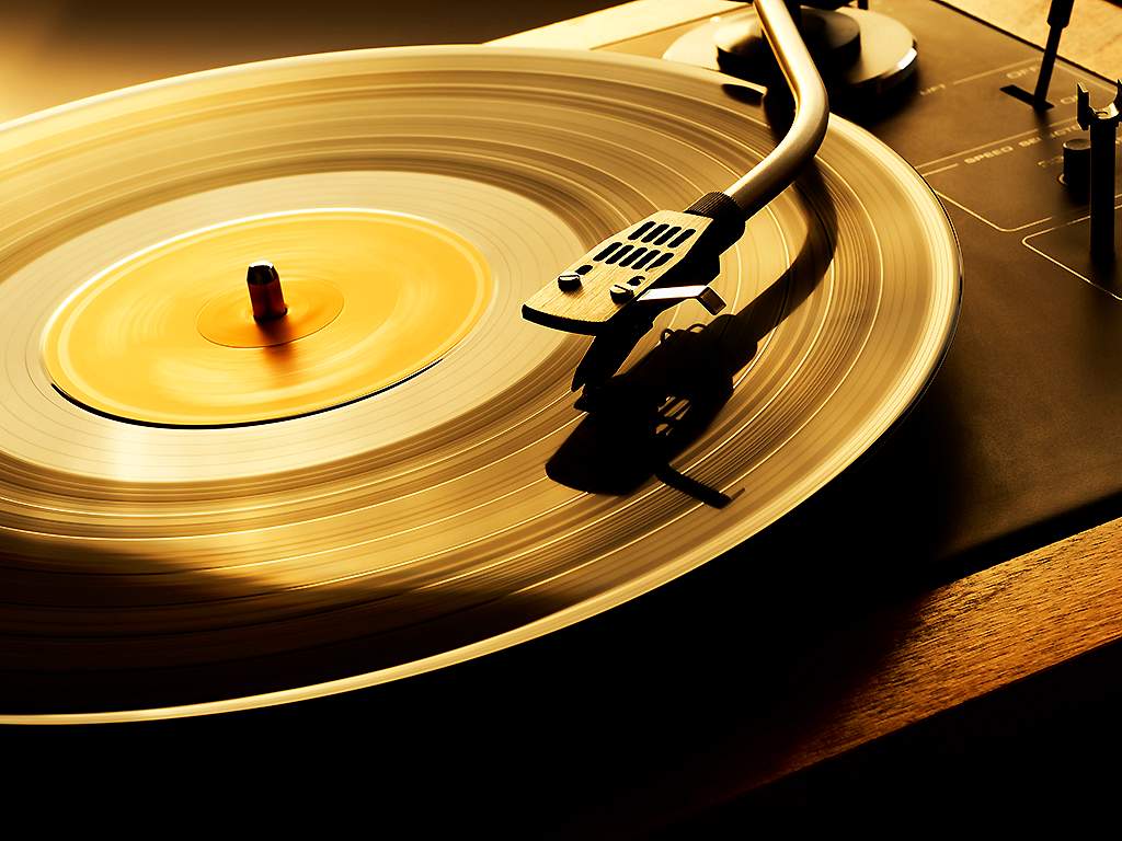 A vinyl record plays on a turntable.