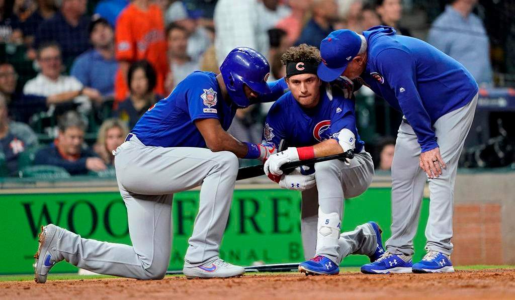 Chicago Cubs' Albert Almora Jr., center, takes a knee as Jason Heyward, left, and manager Joe Maddon, right, talk to him after hitting a foul ball into the stands during the fourth inning of a baseball game against the Houston Astros Wednesday, May 29, 2019, in Houston.