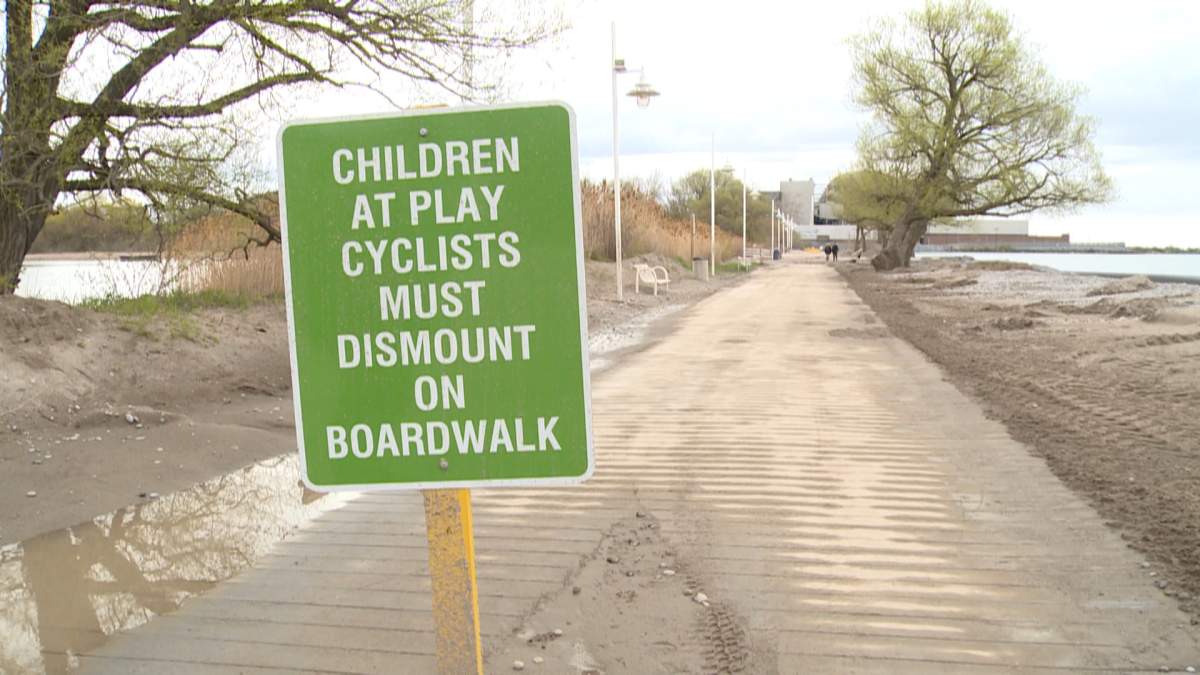 Sand and water can be seen covering parts of the damaged Pickering waterfront boardwalk as a result of Lake Ontario's rising waters.